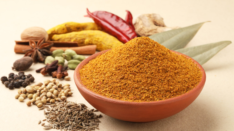 curry powder in bowl with spices