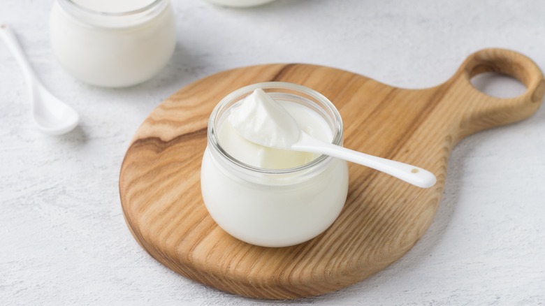 jar of greek yogurt and spoon