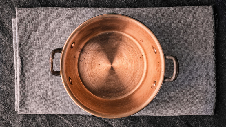 copper pot on grey cloth