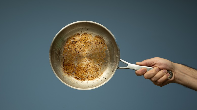 stainless steel pan with scorched bottom