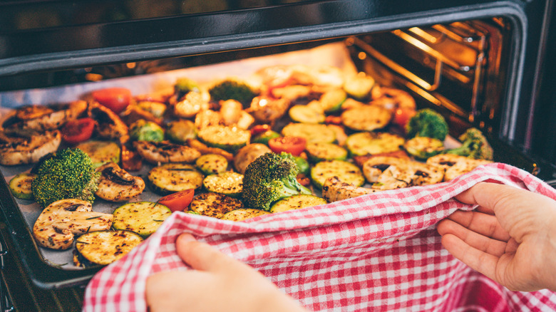 person roasting vegetables