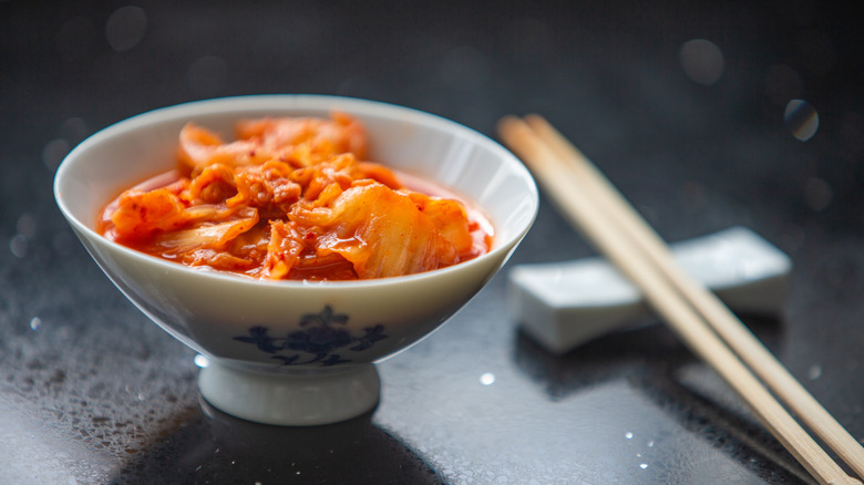 bowl of kimchi with chopsticks