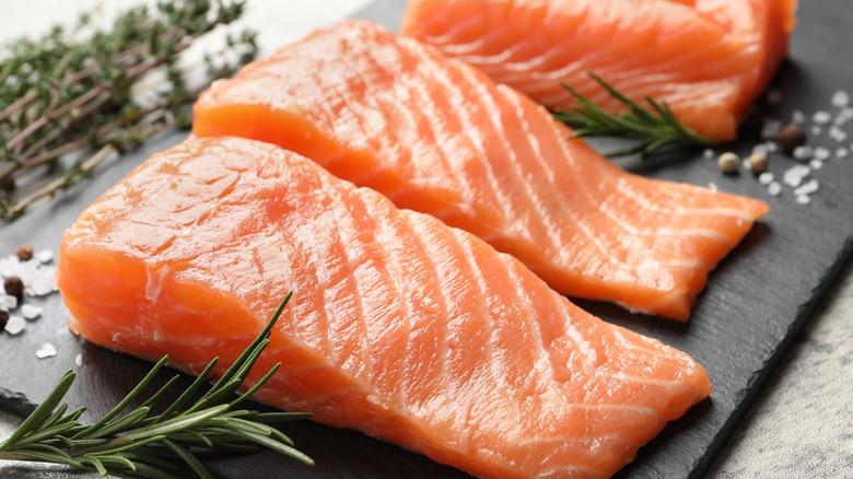 salmon fillets on black stone