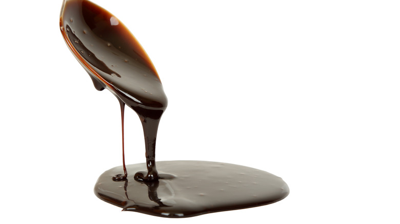 Chocolate syrup dripping off spoon