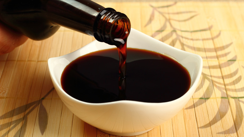 pouring soy sauce into bowl