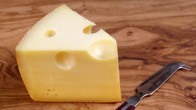 Block of swiss cheese with knife