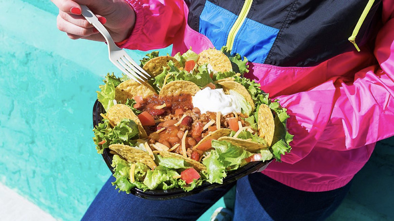 Woman holding Wendy's taco salad