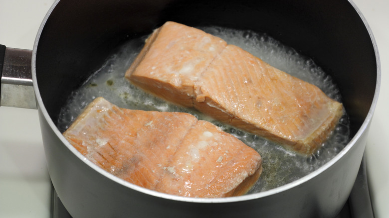 salmon filets poaching in pot