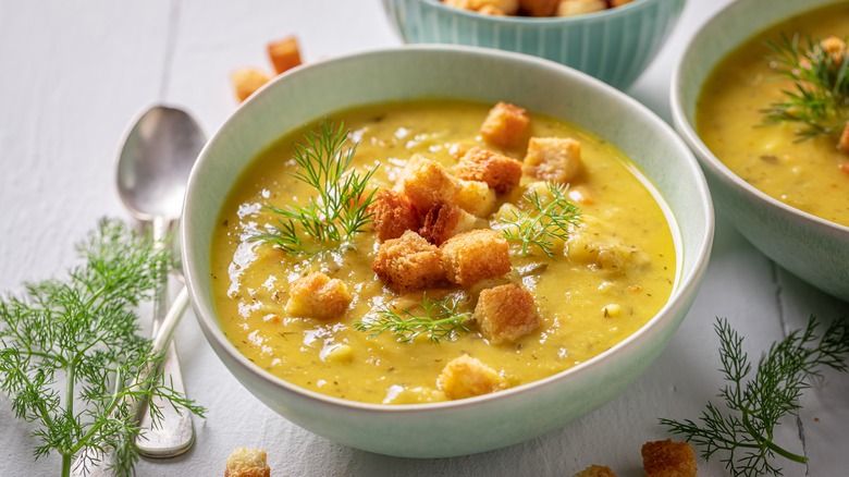 bowl of soup with herbs and croutons