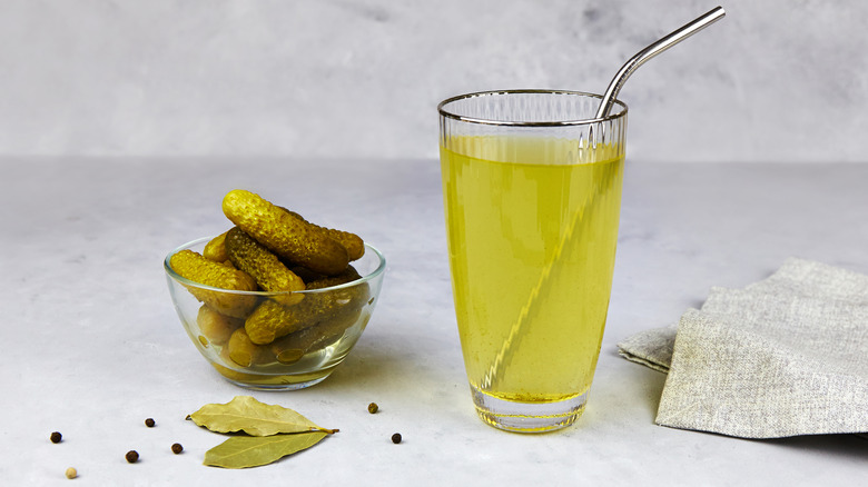 glass of pickle juice with straw