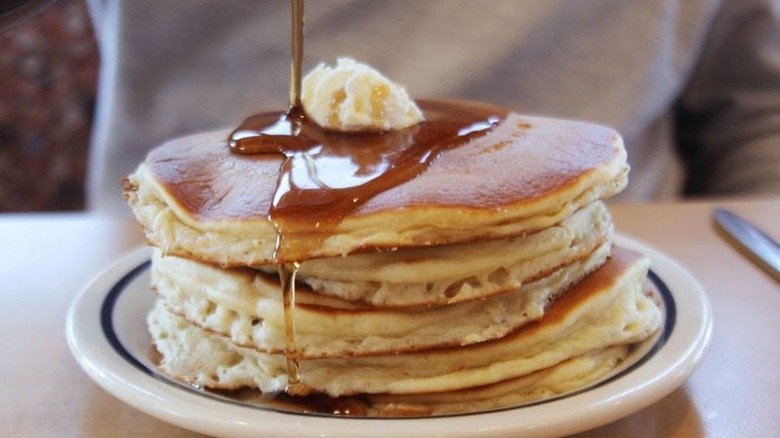 Pouring syrup on IHOP pancakes