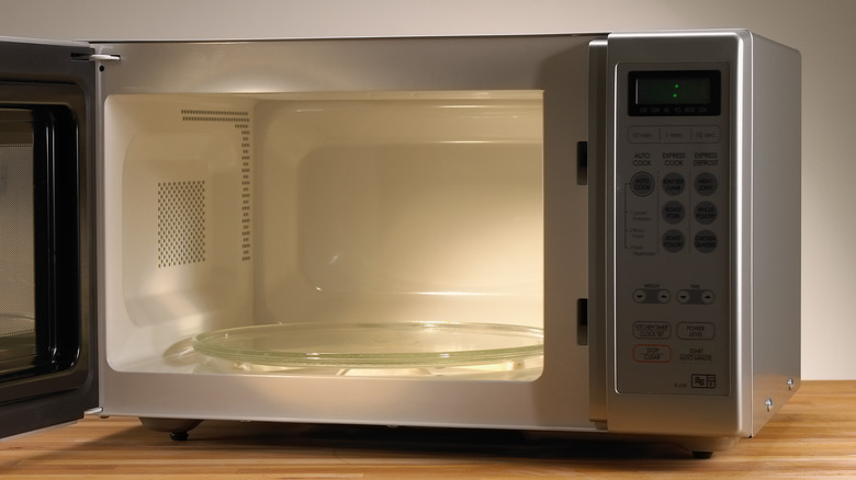 open microwave on wooden countertop