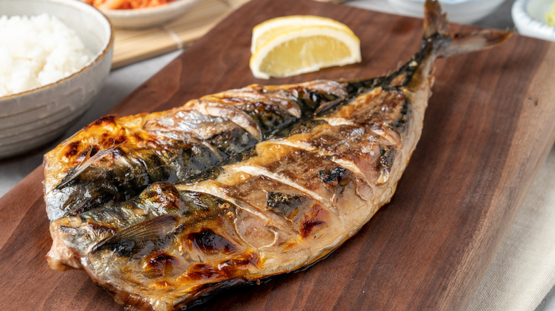 Grilled mackerel on wooden board