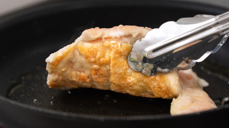 frying chicken thigh in pan