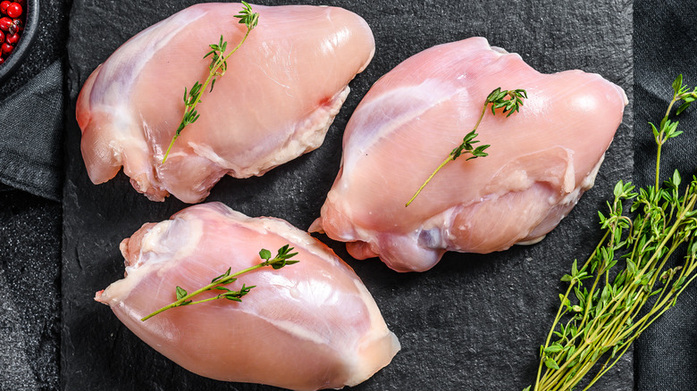 chicken thighs on black board