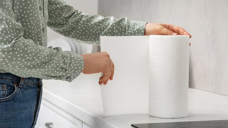 person taking paper towel