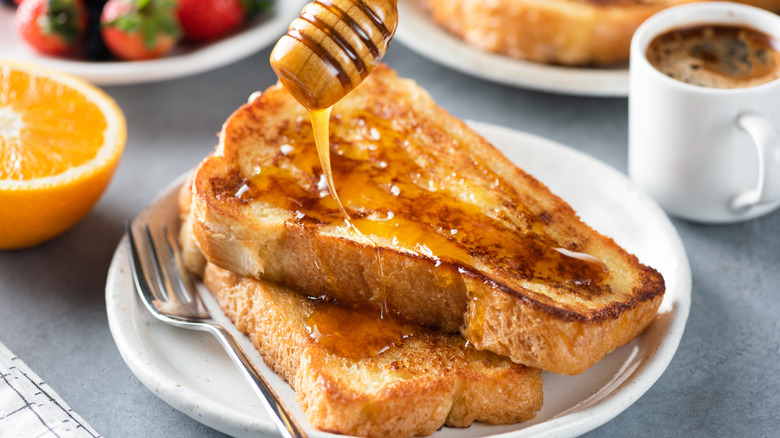 pouring honey on french toast