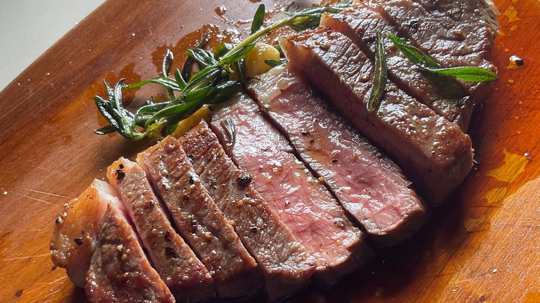 sliced steak with rosemary