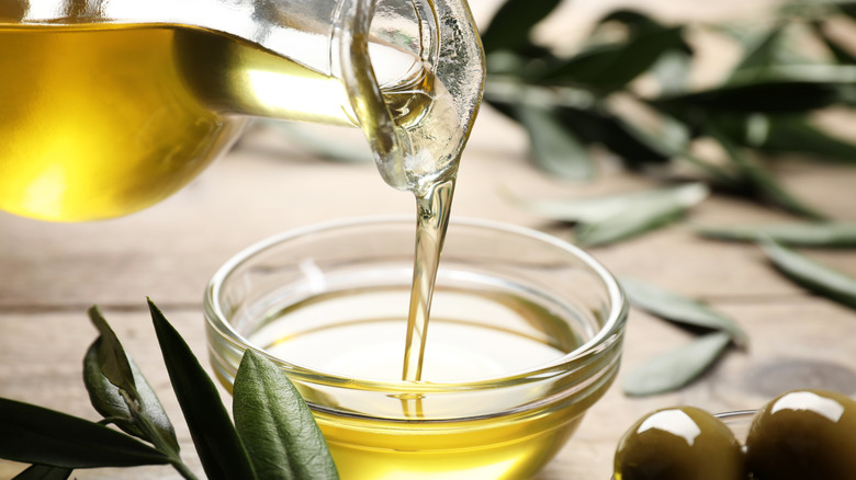 pouring olive oil from jug