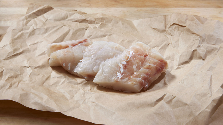 raw cod fillets on paper