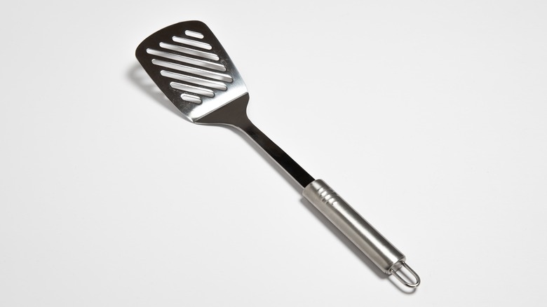 silver spatula on white backdrop