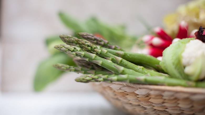 asparagus in basket with vegetables