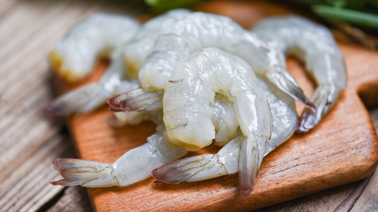 Wooden platter of white shrimp