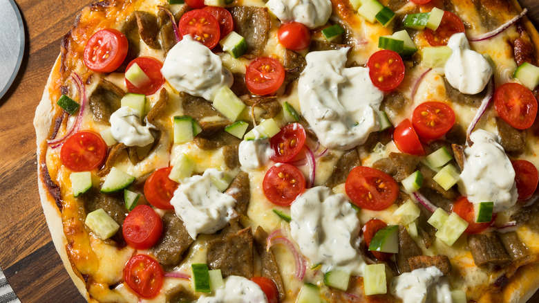 Gyro meat on pizza with tzatziki