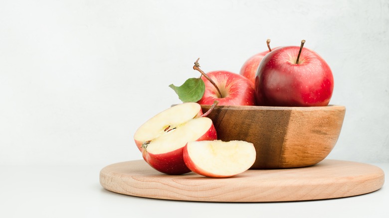 wooden plate with red apples