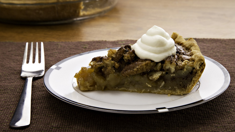 slice of pecan pie with whipped cream