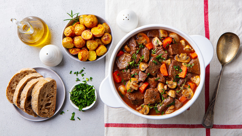 Beef bourguignon with bread and potatoes