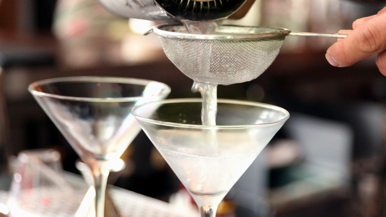 martinis being poured into glasses