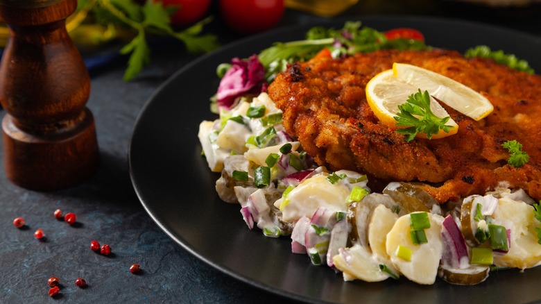 Potato salad with breaded meat on top