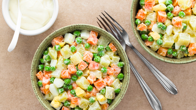 Potatoes, peas, carrots in bowl