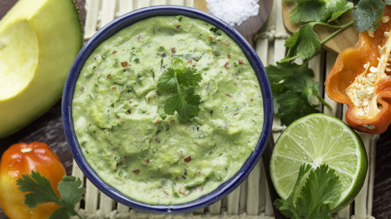 bowl of guacamole with ingredients