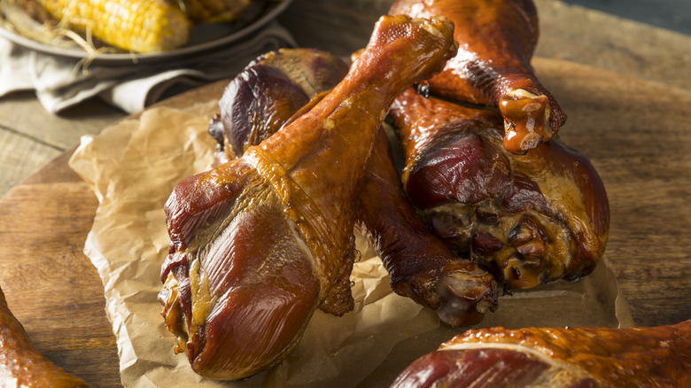 smoked turkey legs on wooden board