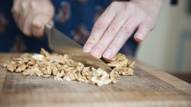 Chopping walnuts with a big knife