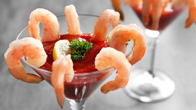 shrimp cocktail in glass with sauce and garnish