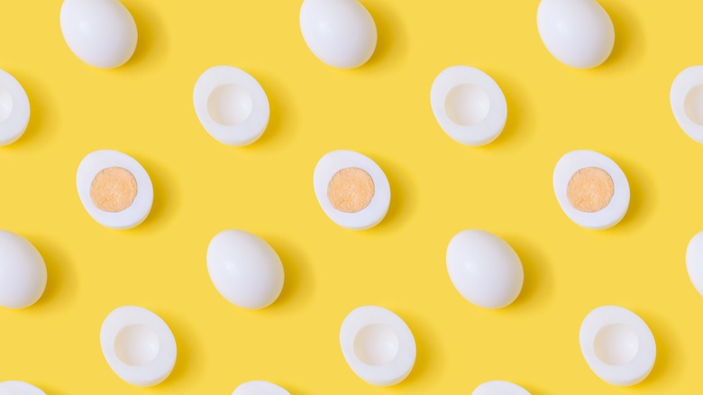 sliced boiled eggs yellow background