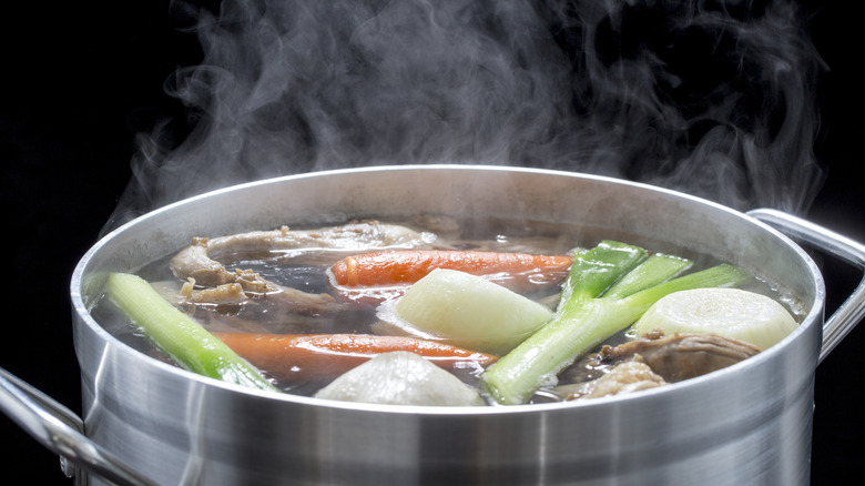 chicken broth simmering on stove