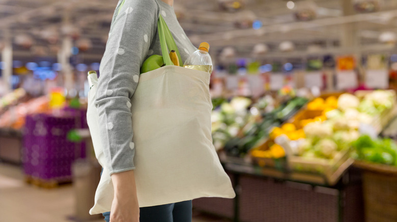 person carrying a canvas bag