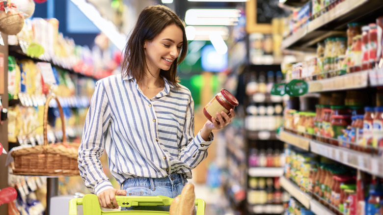 Woman checking price of a jar