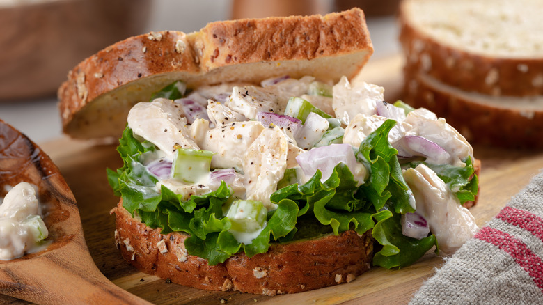 Creamy chicken salad made with mayo on a sandwich with lettuce