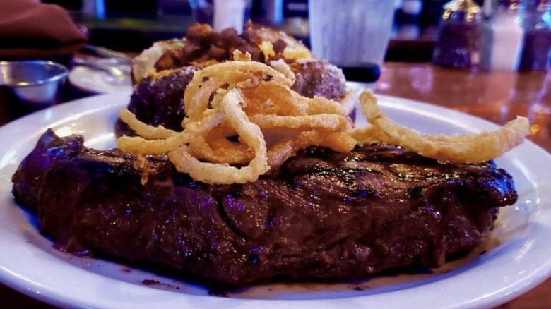 steak with onion rings plated