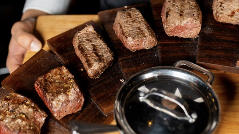 selection of steaks on boards