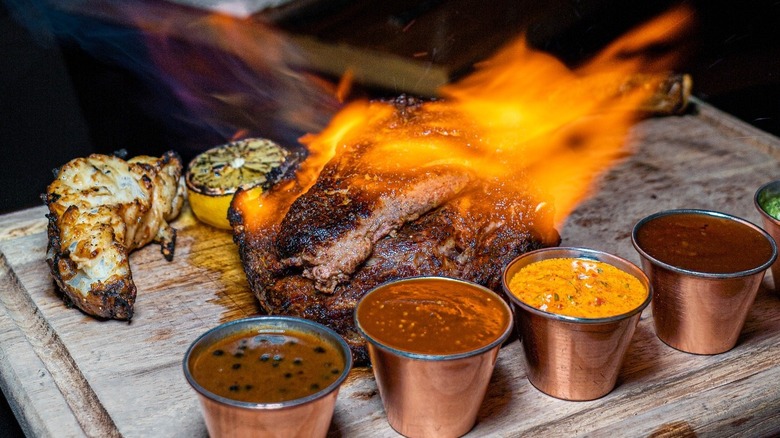 Flaming steak on a board