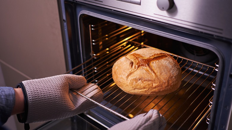 bread being pulled from oven