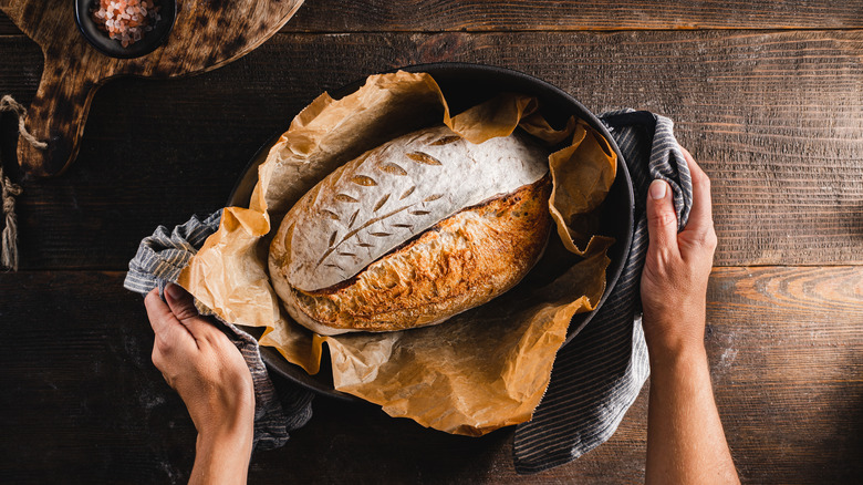 person with freshly baked loaf