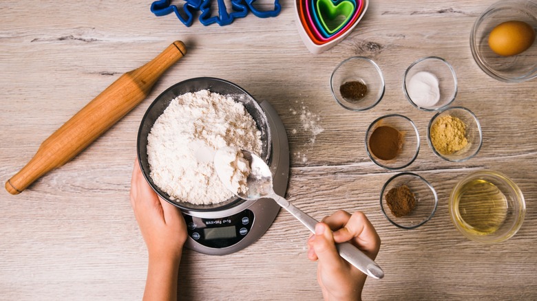 person weighing out flour