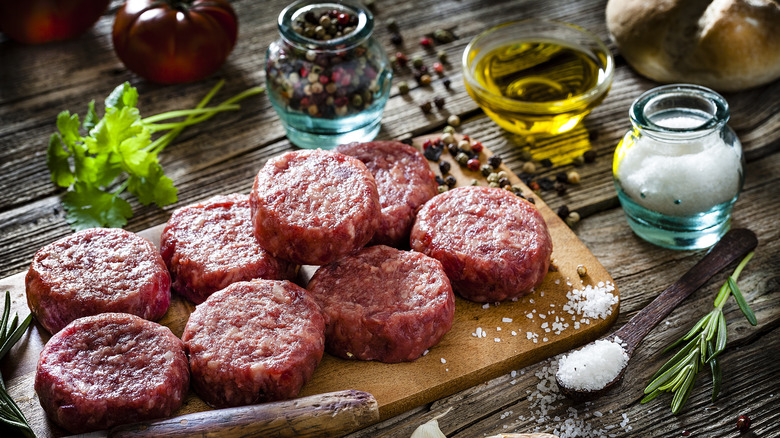 burger patties with seasoning jars